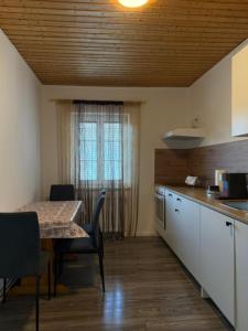 a kitchen with a table and a table and chairs at Caroline in Leoben