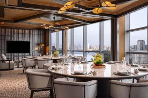 a conference room with tables and chairs and windows at Thompson Shanghai Expo, by Hyatt in Shanghai