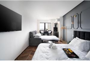 a room with two beds and a chair and a television at City tower 16 floor in Jerusalem