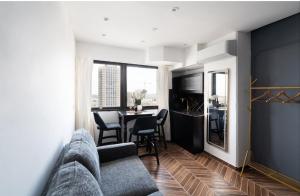a living room with a couch and a table with chairs at City tower 16 floor in Jerusalem