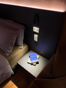 a book sitting on a table next to a bed at AUTRA Resort Middleton in Middleton
