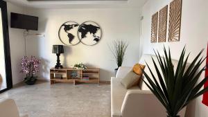 a living room with a couch and a tv at Hotel Abay in Rimini