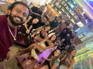 a group of people posing for a picture in a casino at Funky Monkey Surfhostel Hiriketiya in Hiriketiya