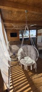 a swing in a room on a boat at Mobile home Bokun sriće in Drage