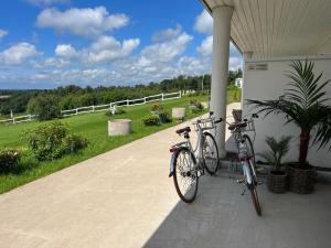 two bikes parked on the porch of a house at Killeröd Boutique Apartments in Båstad