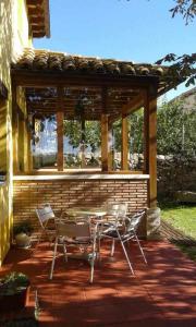 a patio with a table and chairs and a pavilion at Casa Rural El Hidalgo en Amaya Burgos in Amaya