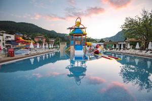 a water park with a water slide in the water at Spa Hotel Persenk in Devin