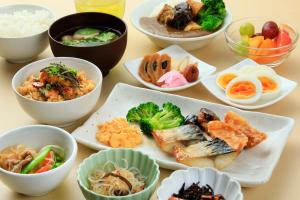 a table topped with bowls of different types of food at Richmond Hotel Narita in Narita