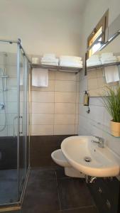 a bathroom with a toilet and a sink and a shower at Hotel Abay in Rimini +44 photos