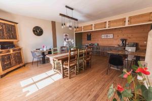 a kitchen and dining room with a table and chairs at Les Greniers in Myon