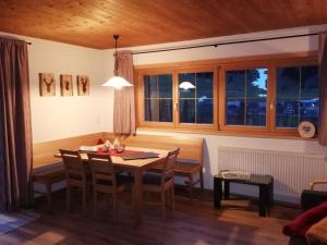 a dining room with a table and chairs at Bungalow Müller in Brand +25 photos