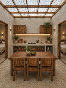 a dining room with a table and chairs and a ceiling at Alba Villa in Gili Trawangan