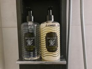 two bottles of natural soap sitting on a shelf at Rhódia & Sun by Booking Kottas in Ixia