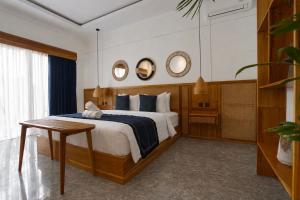 a bedroom with a bed and two mirrors on the wall at Penida Green Palm Cottage in Nusa Penida +48 photos