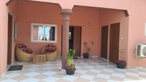 a porch of a house with potted plants at DAVADI loc in Cotonou