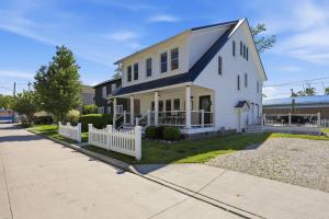 a white house with a blue roof at Dragonfly Guest House-GOTL Strip in Geneva +63 photos