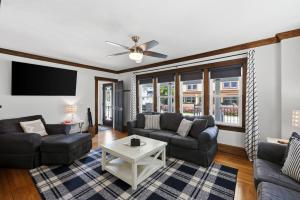 a living room with couches and a flat screen tv at Dragonfly Guest House-GOTL Strip in Geneva