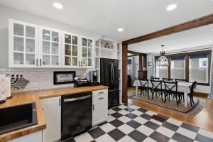 a kitchen with a black and white checkered floor at Dragonfly Guest House-GOTL Strip in Geneva