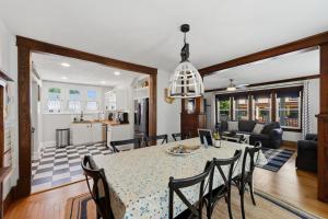 a dining room and living room with a table and chairs at Dragonfly Guest House-GOTL Strip in Geneva