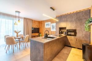 a kitchen with a counter and a table with chairs at Casa Lipa in Horní Maršov