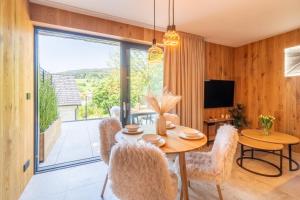 a dining room with a table and chairs and a television at Casa Lipa in Horní Maršov