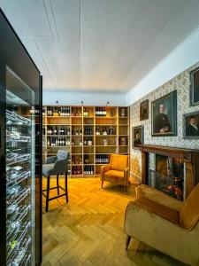 a living room with a fireplace and a chair at DU GLACIER Boutique & Traditions Hotel in Fiesch +114 photos