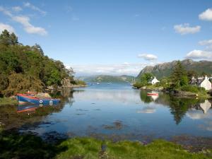 a body of water with boats in it at Ferry Cottage - Balmacara in Coillemore
