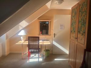 a room with a desk and a table with a chair at Hôtel Chandouineau in Redon +31 photos