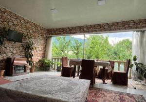 a living room with a table and a stone wall at Panoramic apartment in Gabala