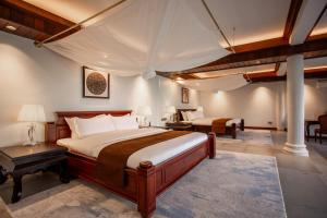 a bedroom with two beds and a table and chairs at Koh Totung Resort in Kaoh Sdach +71 photos