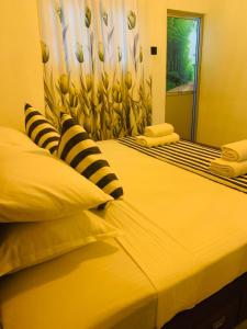 two beds sitting next to each other in a bedroom at jungle view in Nilwella