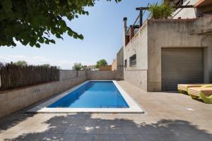 a swimming pool in the backyard of a house at Els Castellers in Sant Pau dʼOrdal