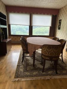 a dining room with a table and chairs at Guest room in Retro House in Turku