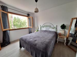 a bedroom with a large bed and a window at Relaxing & Cozy House in Gran Alacant
