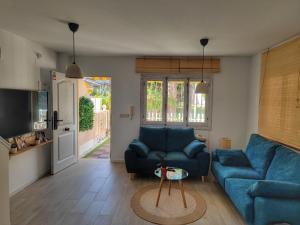a living room with a blue couch and a table at Relaxing & Cozy House in Gran Alacant