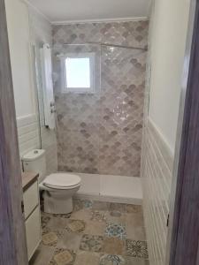 a bathroom with a toilet and a window at Relaxing & Cozy House in Gran Alacant +17 photos