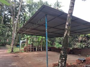a metal canopy on top of a tree at Rooms In Canacona in Canacona