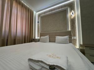 a bedroom with a white bed with a white blanket on it at Khazri Resort & Villas in Baku +88 photos