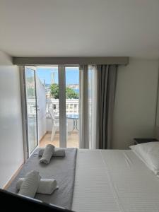 a bedroom with a bed and a view of a balcony at Apartments Villa Simoni in Split