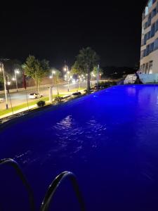 a large pool of blue water at night at Appart Hôtel Cabo Dream in Cabo Negro +12 photos