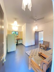 a living room with a bed and a chair in it at Casa de sazu 1bhk in Mandrem