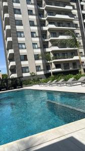 a swimming pool in front of a large building at Luxury Aestethics at Bantree in Accra