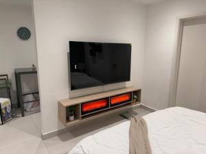 a living room with a flat screen tv on a wall at Luxury Aestethics at Bantree in Accra
