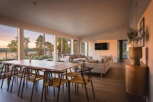 a living room with a wooden table and chairs at Stay North - Harmonia in Halslahti