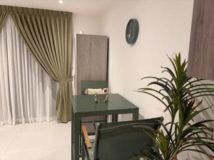 a room with a green desk and a mirror at Luxury Aestethics at Bantree in Accra