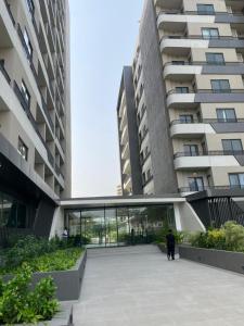 a person walking in front of a large building at Luxury Aestethics at Bantree in Accra