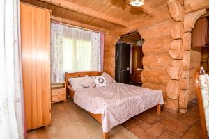 a bedroom with a bed in a log cabin at Willa Anna Bukowina Jacuzzi & Sauna in Bukowina Tatrzańska +73 photos