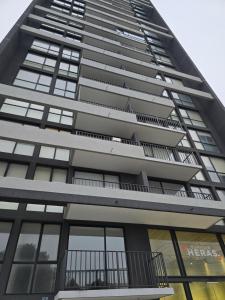 a tall apartment building with a lot of windows at Apartamento Céntrico y Equipado in Concepción