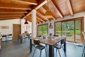 a dining room with a large wooden table and chairs at Agriturismo Amoler in Mirano