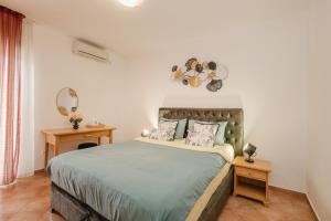 a bedroom with a large bed and two night stands at Apartments Đurašević in Sveti Stefan +107 photos